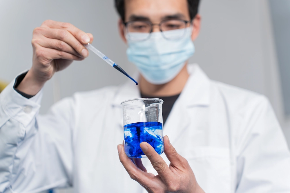 R&D personnel mixes the formula before testing and calibration