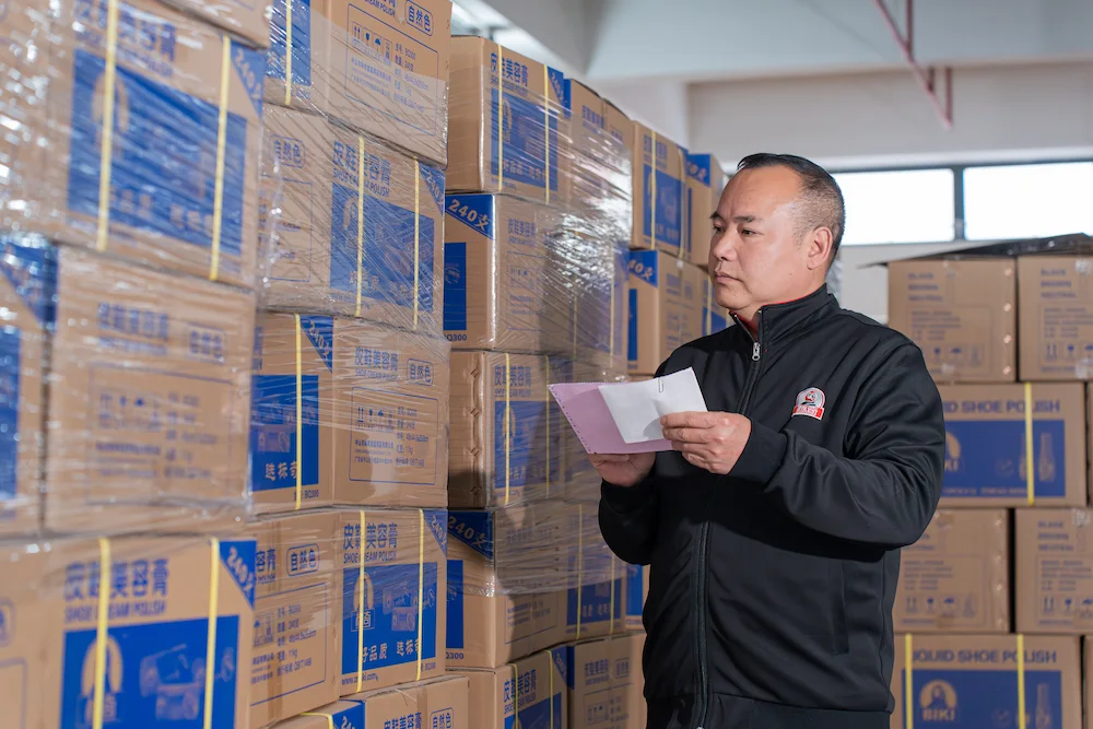 a packaging inspector checks the labels and seals on each carton