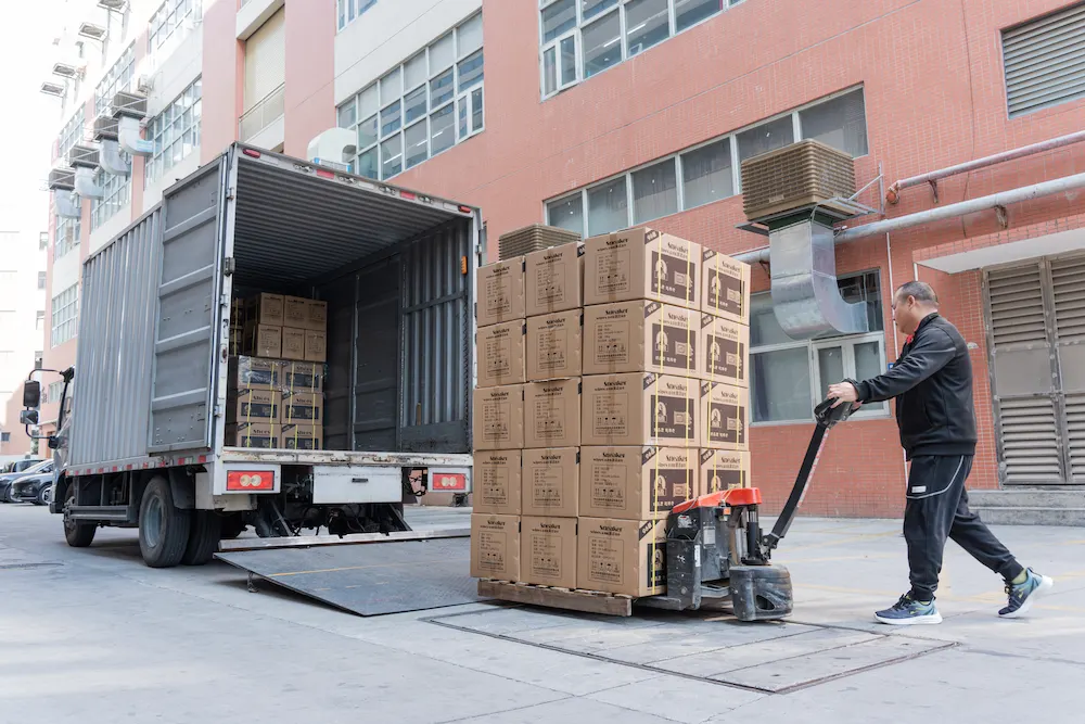 a crate of shoe cleaning products being loaded in a delivery truck