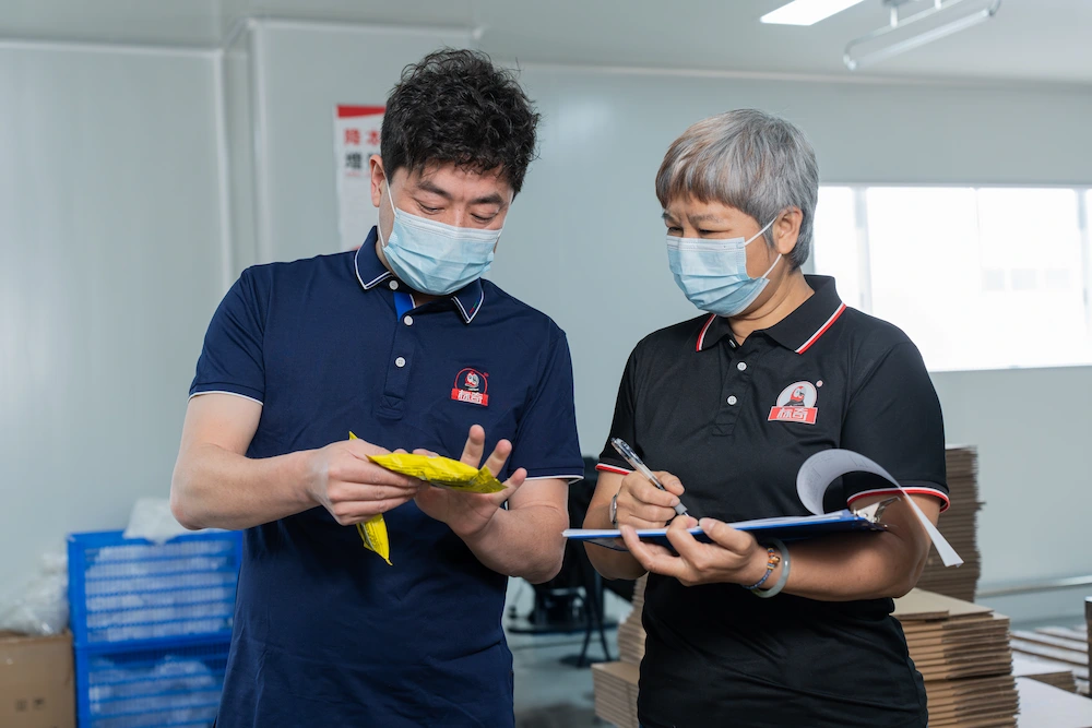 inspectors checking the completed package of sneaker wipes